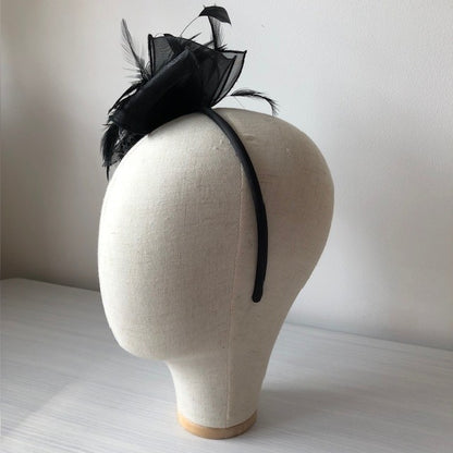 Fascinator black on a slim headband with soft quail feathers with a black bow MHB12