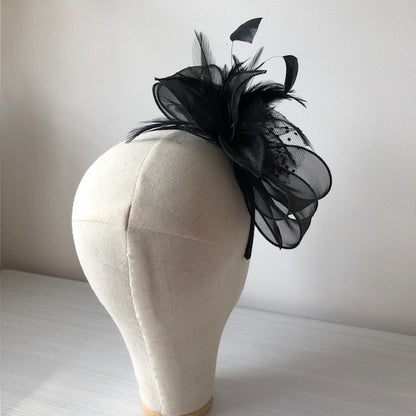 Fascinator black on a slim headband with soft quail feathers with a black bow MHB12