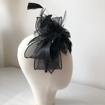 Fascinator black on a slim headband with soft quail feathers with a black bow MHB12